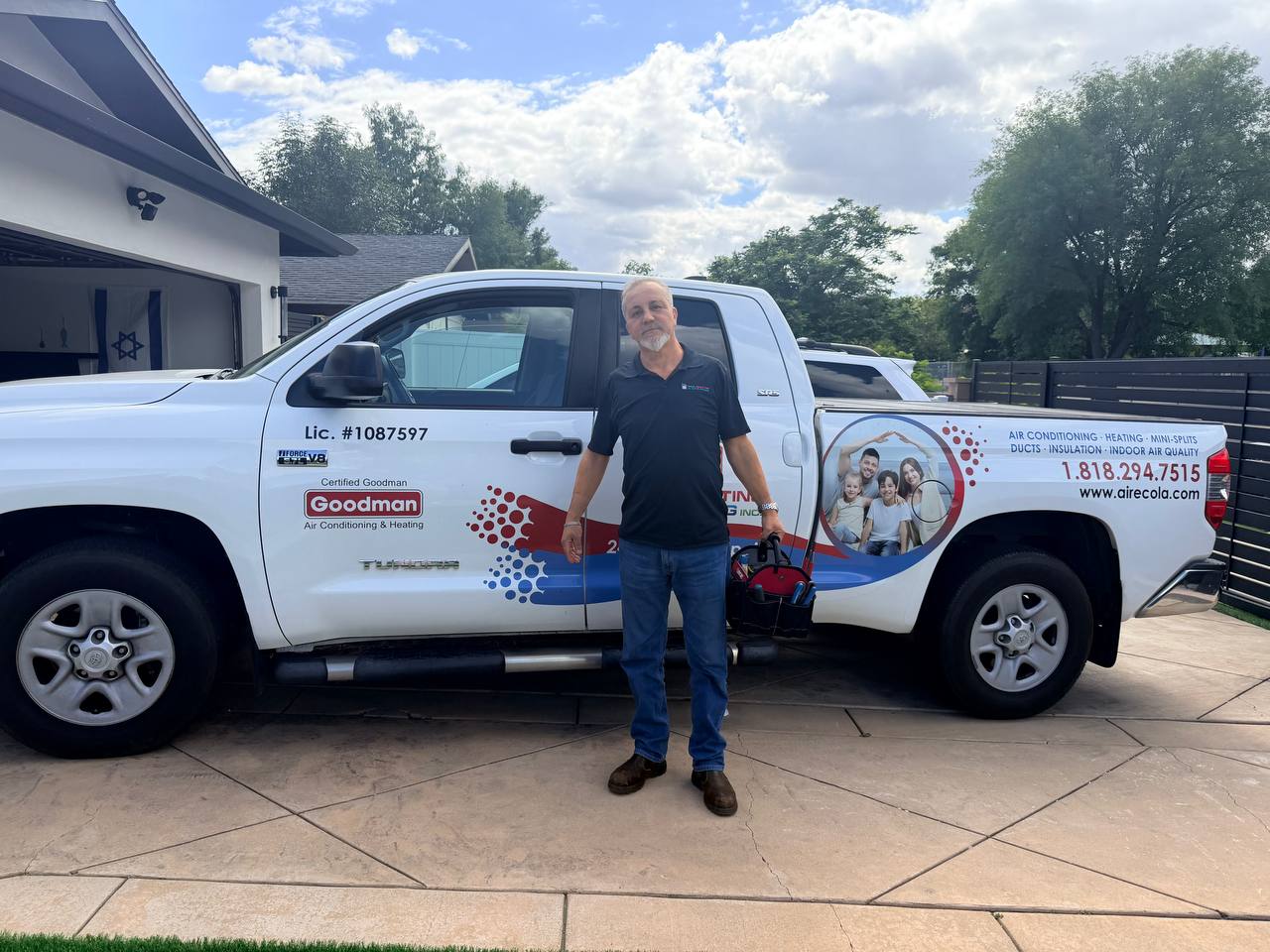 Eli Harosh, owner of ECO Heating & Cooling, standing in front of the company truck in West Hills CA