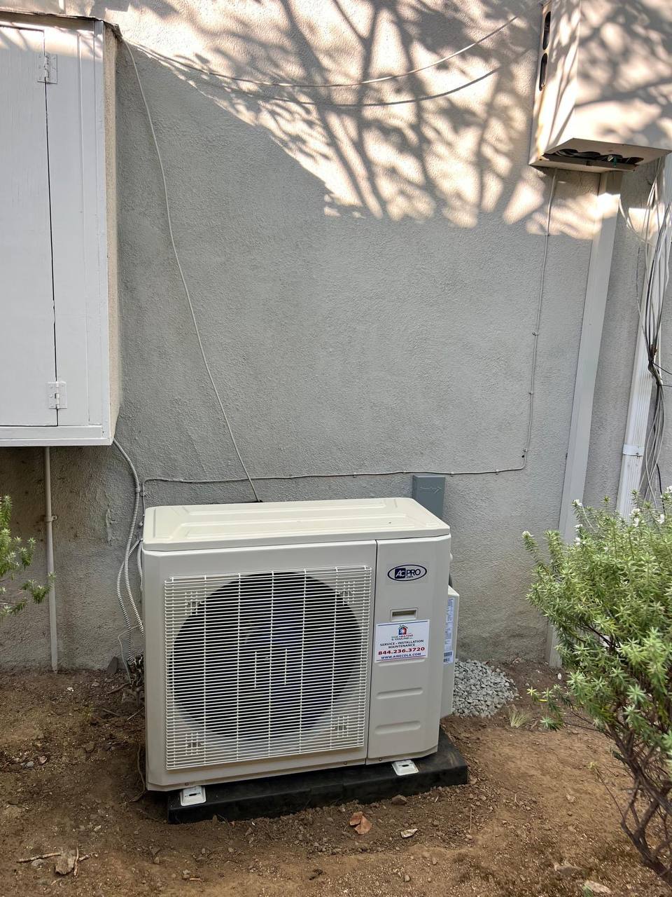 A-Pro mini-split outdoor condenser unit with ECO Heating & Cooling sticker — LADWP rebate-eligible installation
